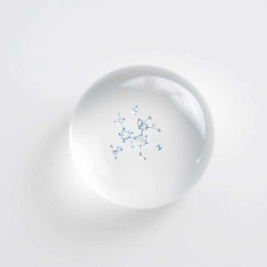 Macro photograph of a serum droplet with suspended peptide molecules